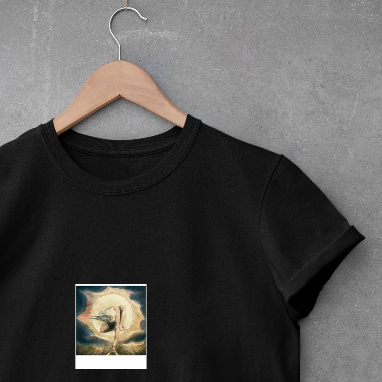 polaroid of zeus on mountain top on hanging black t-shirt.